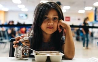 Feeding America stock image of girl with milk
