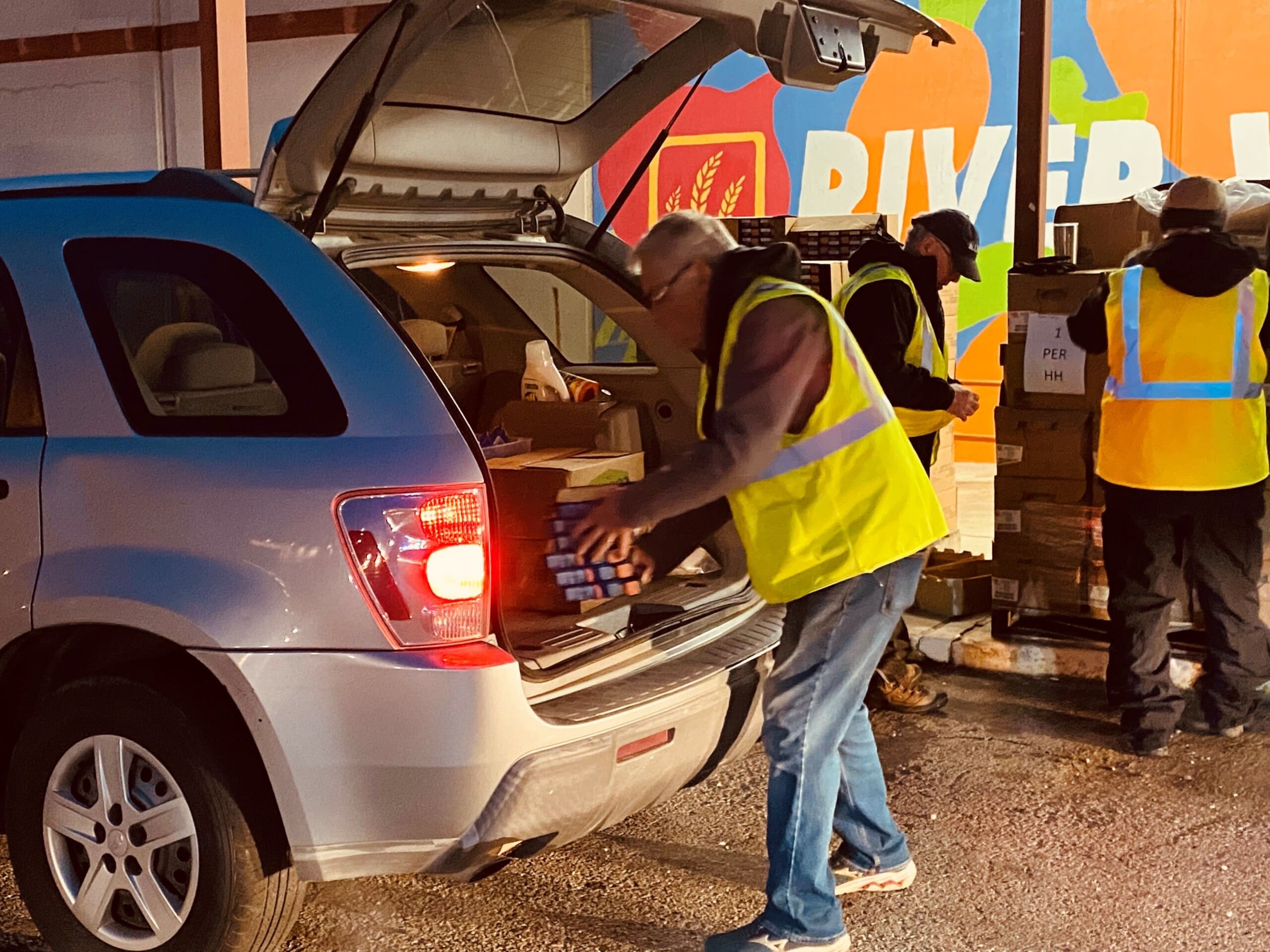 A volunteer loads items into a vehicle at a USDA commodity distribution event in Fort Smith in this undated photo.