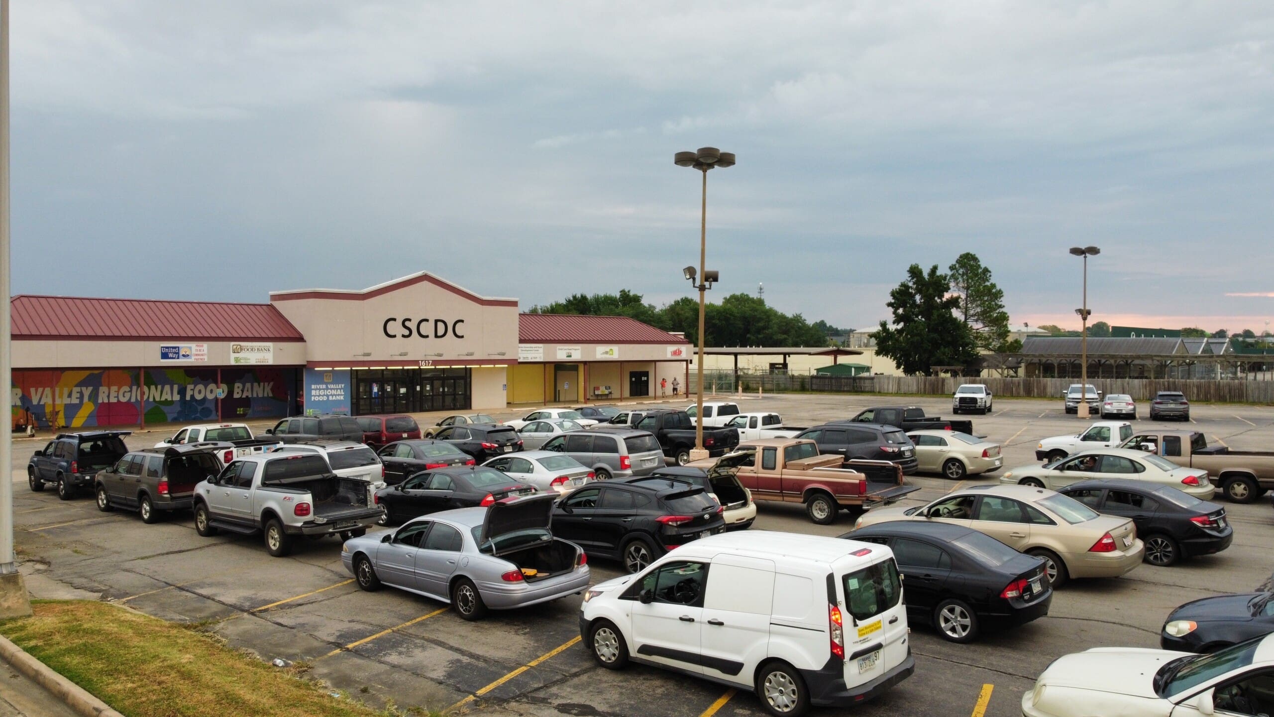 Rows of cars wait in line at the River Valley Regional Food Bank to receive USDA foods during a recent distribution.